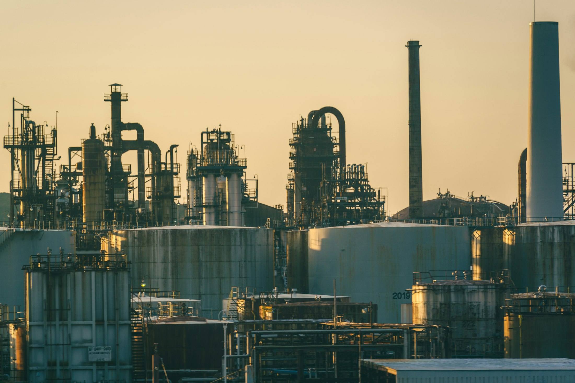 Refinery and storage tanks at golden hour